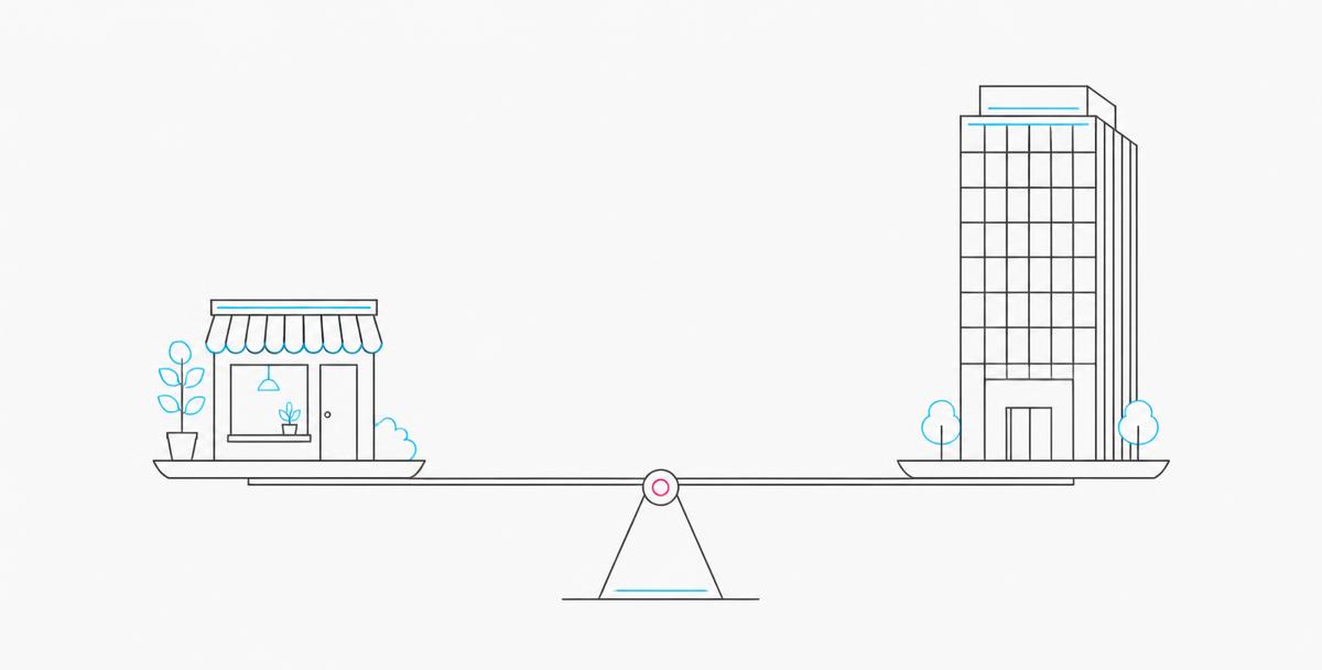 A small shop and a corporate tower balanced evenly on a set of scales